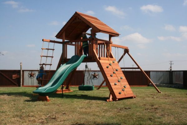 Kids playing on their fort ranchero playset
