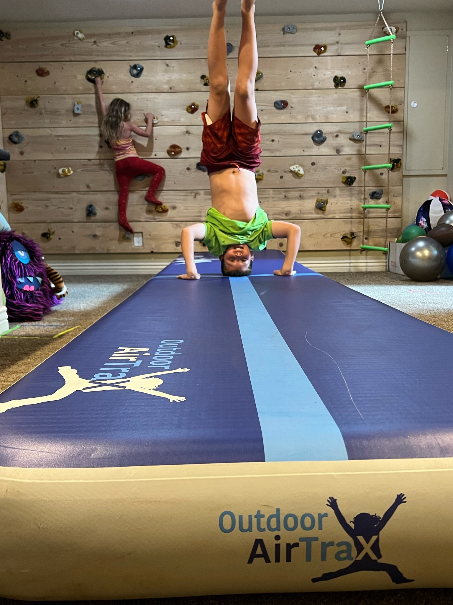 man does head stand on Outdoor Air track
