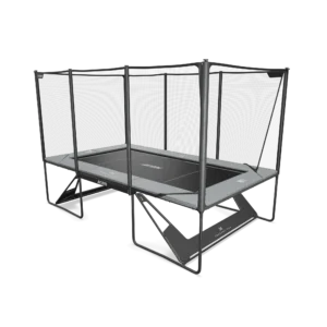 Grey rectangular trampoline with performance mat on it, net around the sides, far away side view